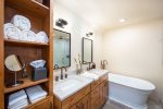The master ensuite features double vanity, walk-in shower & soaker tub.